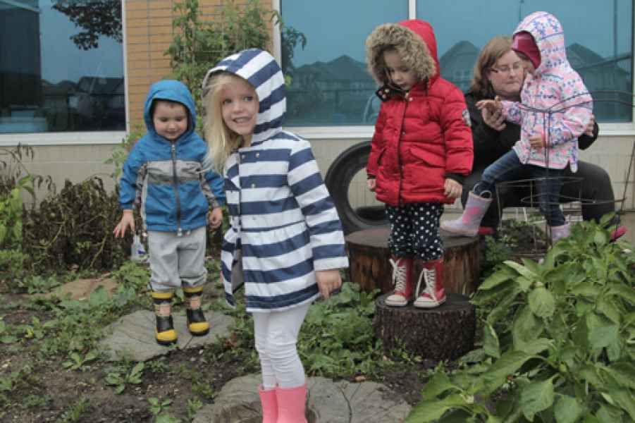 preschoolers stepping in a puddle